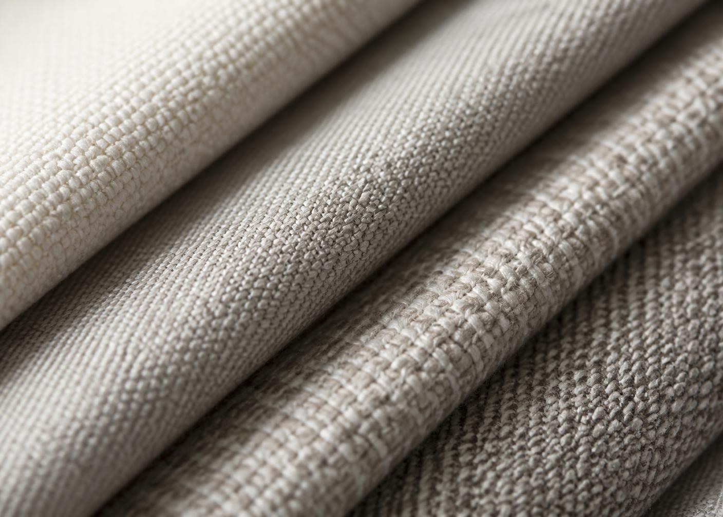 Close-up of premium woven textile swatches in neutral tones